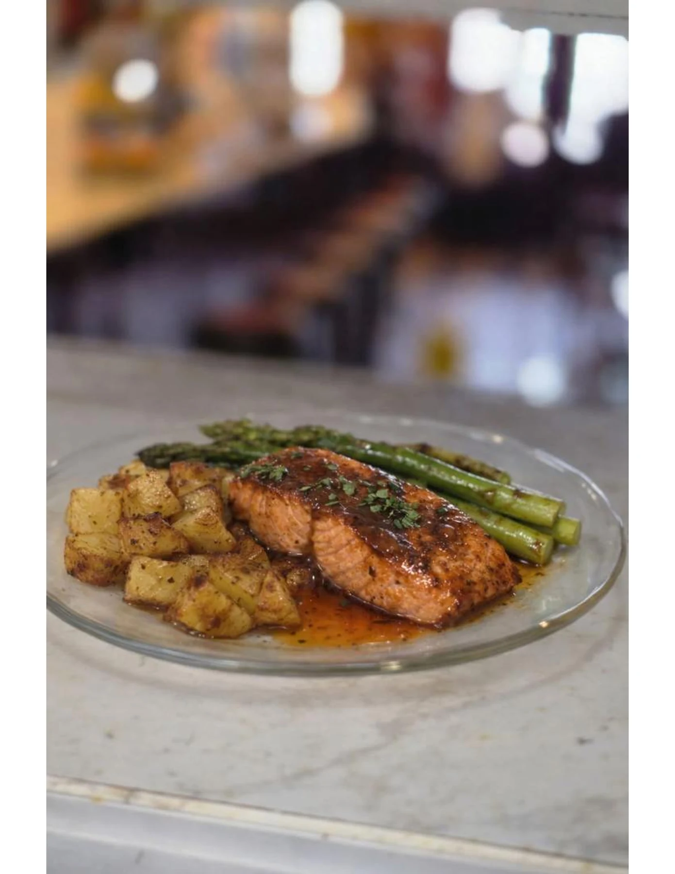 Plated entrée with salmon, asparagus, and roasted potatoes at Dewberry Kitchen & Tap