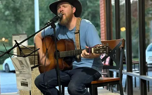 Live music performer at Dewberry Kitchen & Tap — acoustic guitar on Friday nights